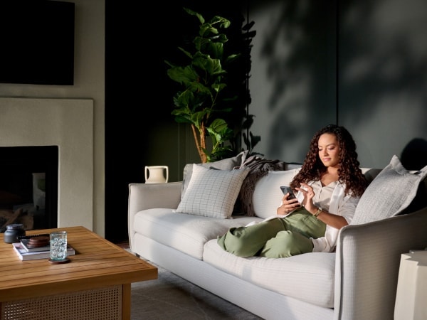customer checking her phone while on the couch