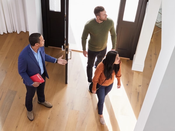 Redfin agent touring the inside of a home with customers