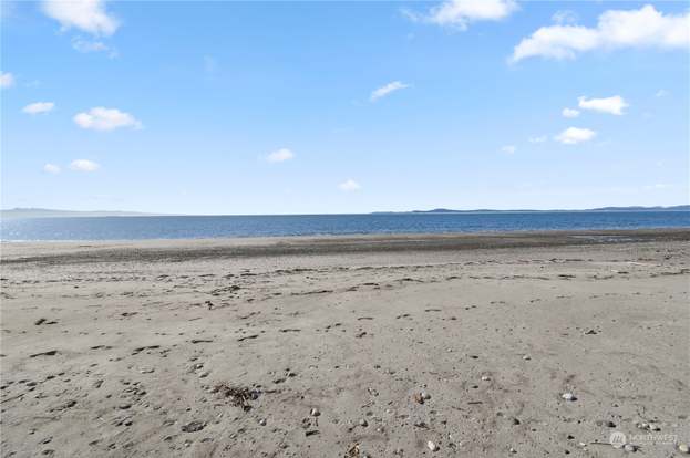 Broad Expanse Of Sandy Dune Complemented By A Clear Blue Sky With