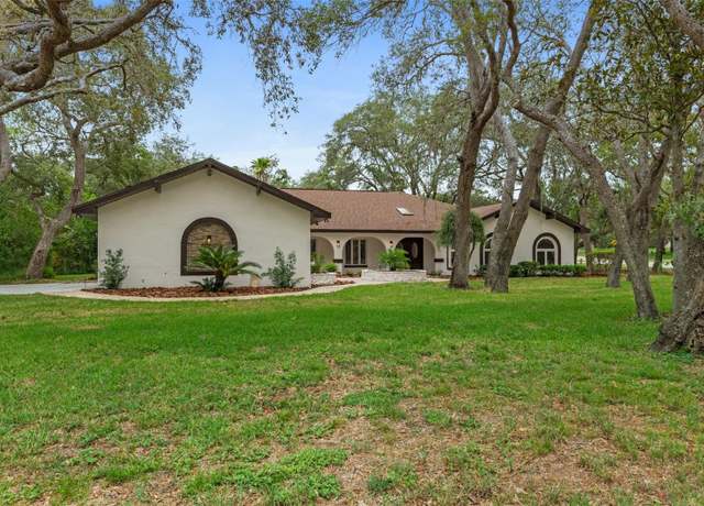 Property at 4595 Lake IN The Woods Dr, Spring Hill, FL 34607, 4 beds, 3 baths
