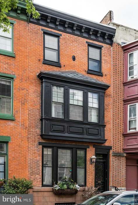 Facade of an unfinished two-story house with no red brick windows