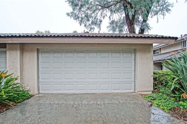 Sectional Wood Garage Door With Decorative Hardware Garage Doors Doors Custom Wood Doors