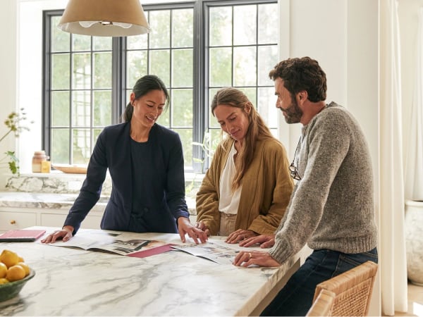 Redfin Agent with two customers talking at a kitchen table