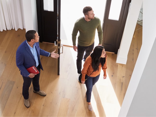 Redfin agent touring the inside of a home with customers