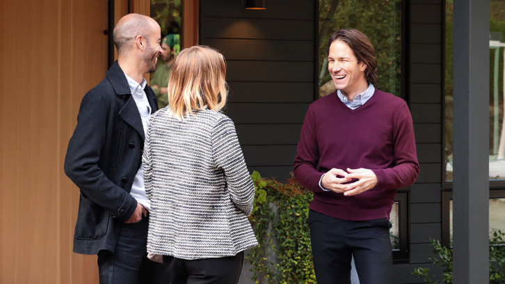three people standing outside