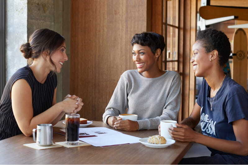 three people sitting at a table